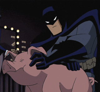 Batman petting a pig